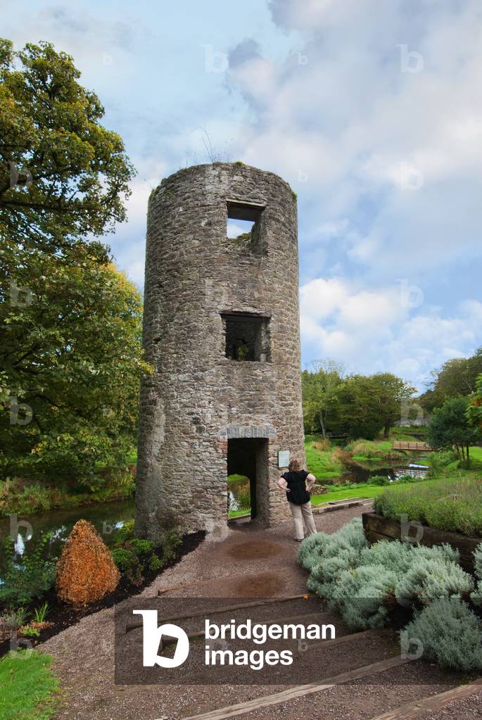 Tourist Looking At Round Tower; Blarney, County Cork, Ireland (photo)