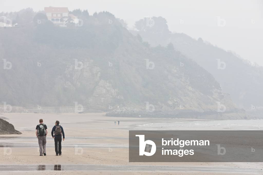 Hikers Walking Along Sands on North Beach, Pembrokeshire Coast, Wales, United Kingdom (photo)