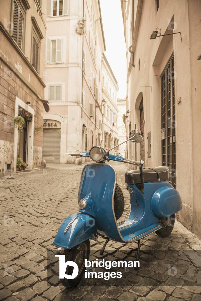 A blue motor scooter parked outside a residential building, Rome, Lazio, Italy (photo)
