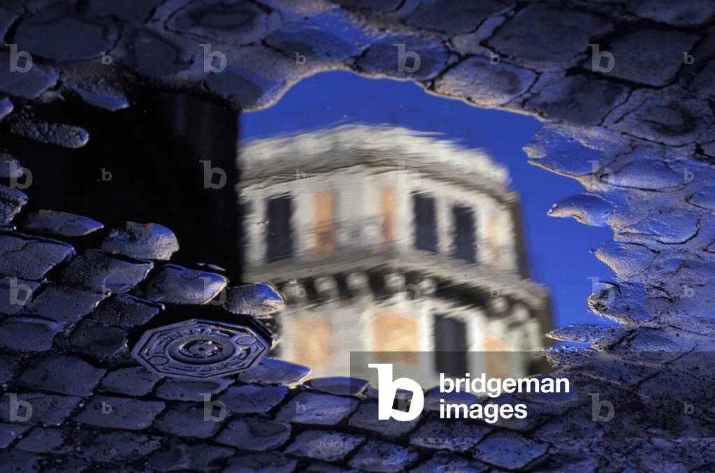 Building top reflecting in pool of water on paved street, Rome, Italy (photo)