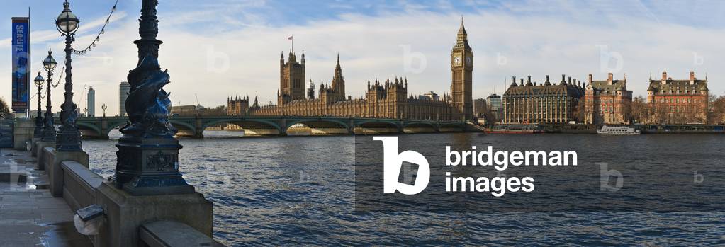 UK, Panoramic view of Houses of Parliament from bank of River Thames, London (photo)