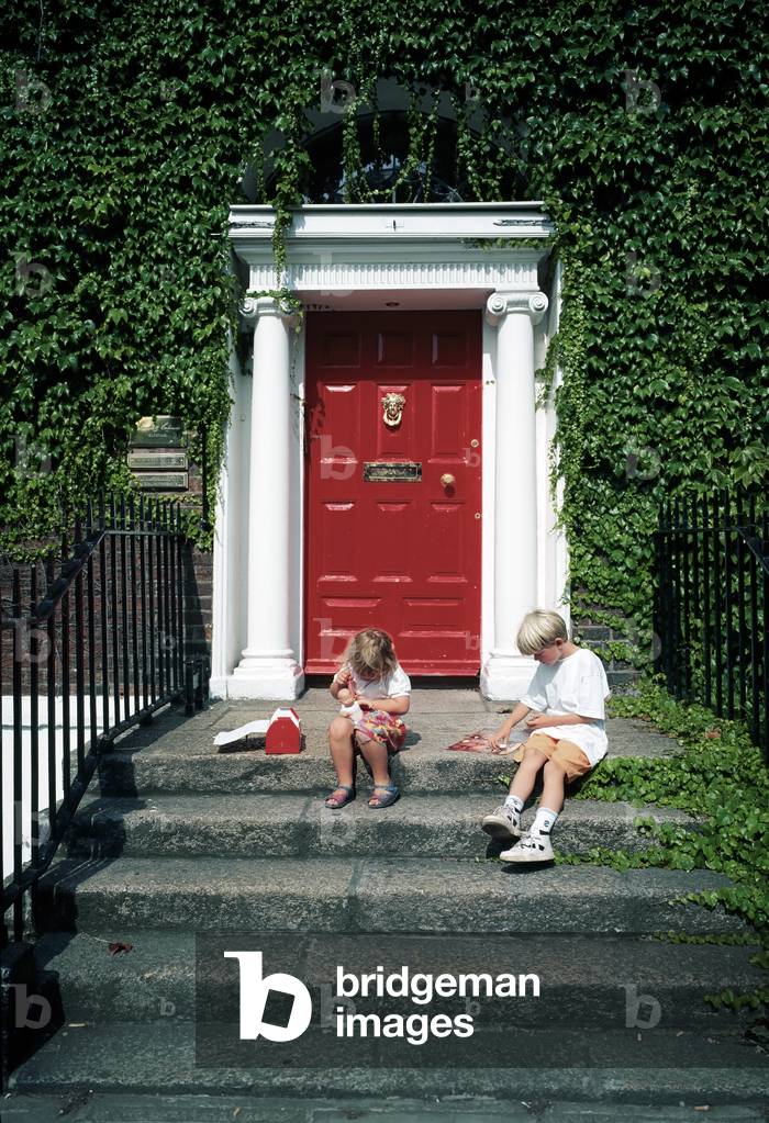 Dublin, Co Dublin, Ireland; Children Sitting Outside Georgian House (photo)