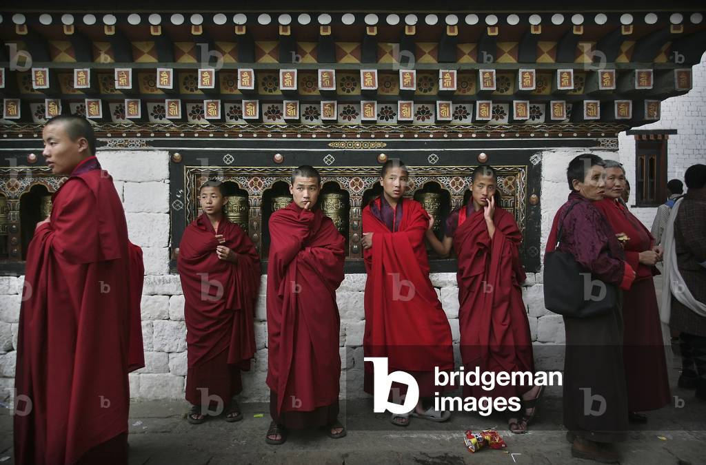 Buddhist Monks by Prayer Wheels (photo)