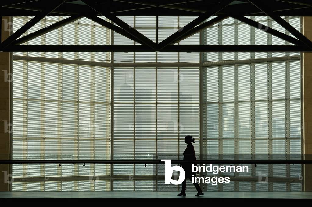 Qatar, Silhouette of woman against large window in Museum of Islamic Art, Doha (photo)