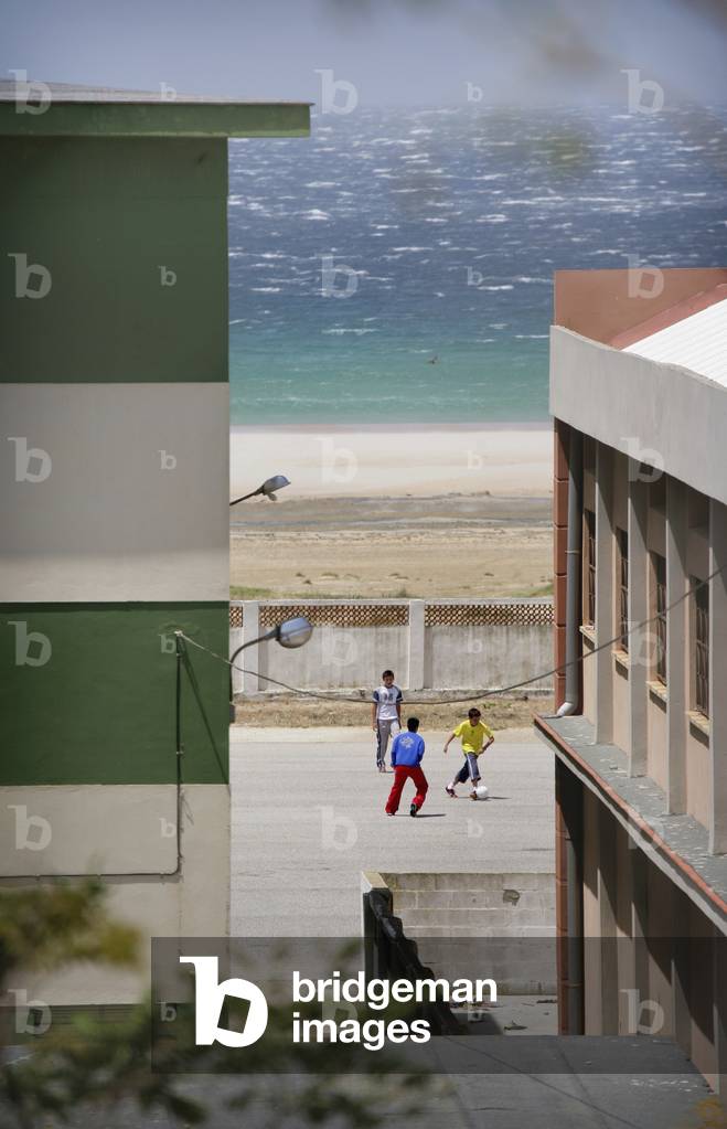 Spain, Andalucia, Costa De La Luz, Children Playing Football By Beach, Tarifa (photo)