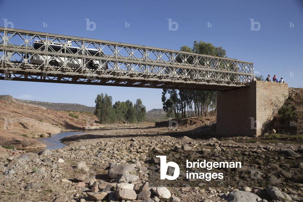 Tourist bus crossing broken bridge, Gheralta, Tigray region, Ethiopia (photo)