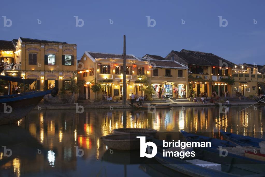Vietnam, UNESCO World Heritage Site, Hoi An, Town waterfront of historic town at dusk (photo)