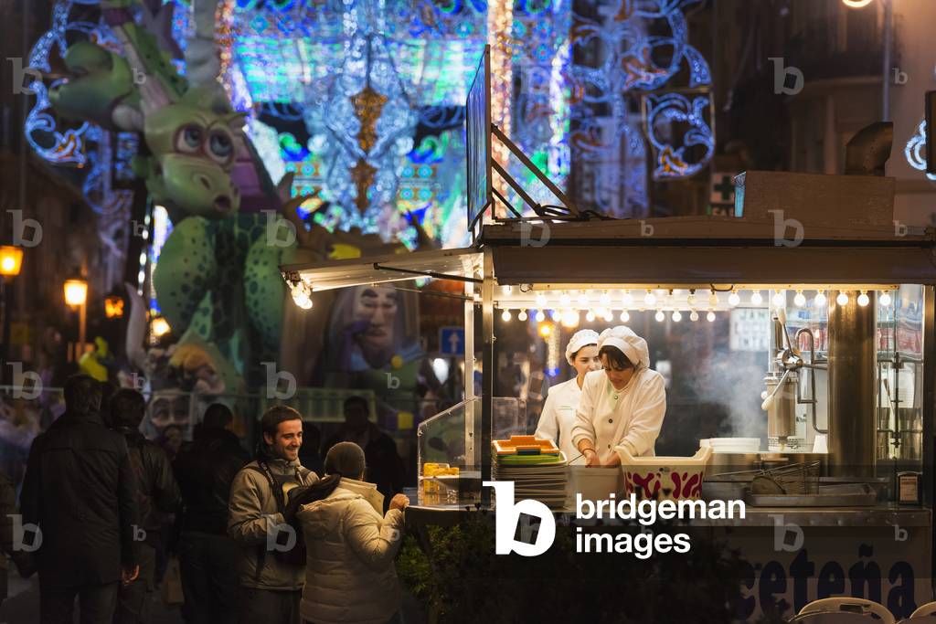 People Buying Churros During Fallas Festival, Valencia, Spain (photo)