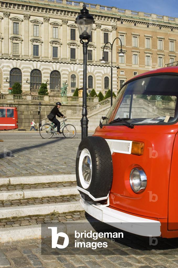 Cyclist Passing Royal Palace Located on Stadsholmen (City Island) in Gamla Stan (Old Town), Stockholm, Sweden (photo)