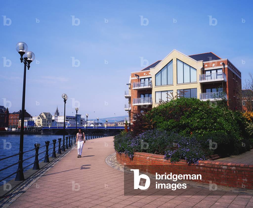 Belfast, Co Antrim, Northern Ireland; Woman Walking Past The Lagan River (photo)