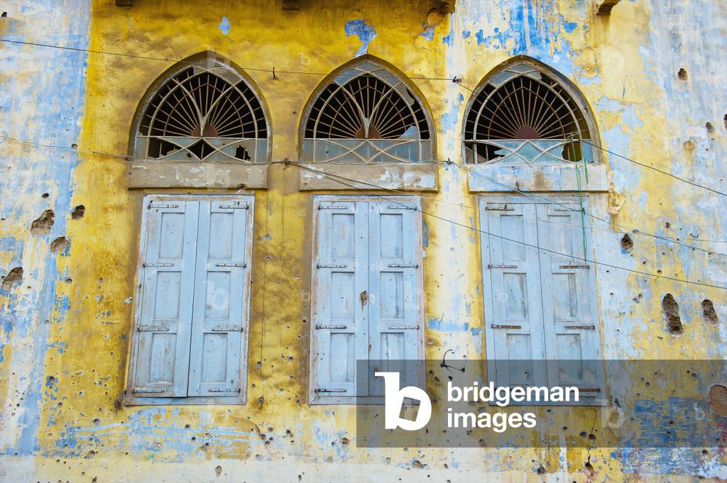 Broken windows and old shutters on a weathered and worn building, Beirut, Lebanon (photo)