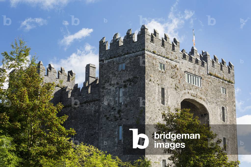 Stone castle with trees, blue sky and clouds; Bunratty, County Clare, Ireland (photo)