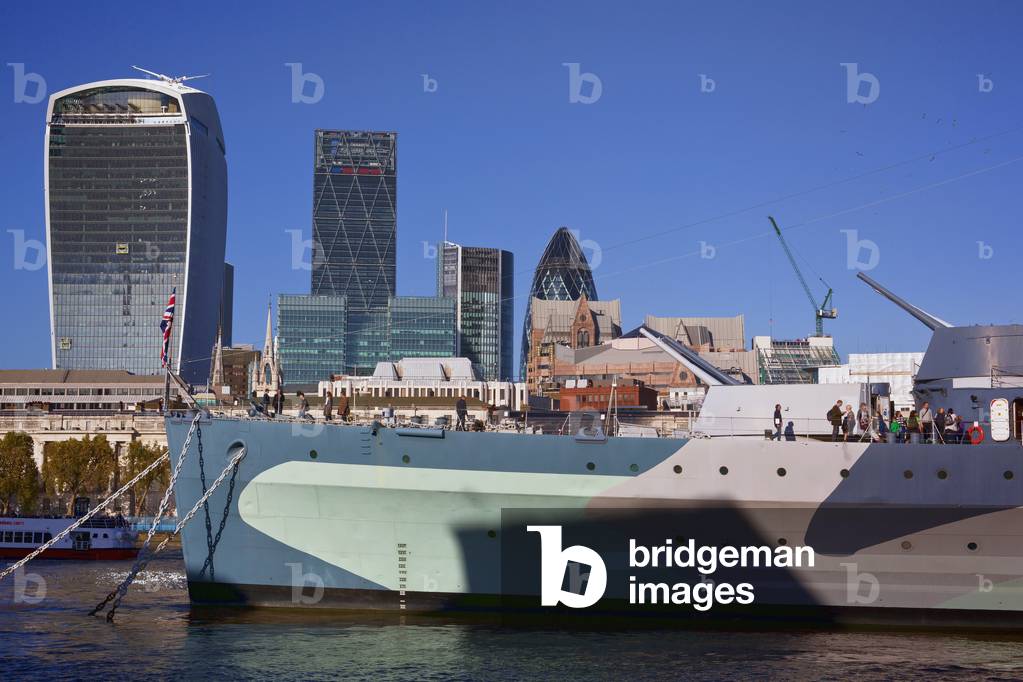 The HMS Belfast, WWII battleship, and the buildings of the City of London, the financial district, with the River Thames, London, England, UK  (photo)