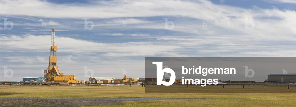 Oil and gas drill rig with surrounding infrastructure, Prudhoe Bay, Arctic Alaska, USA, Summer (photo)