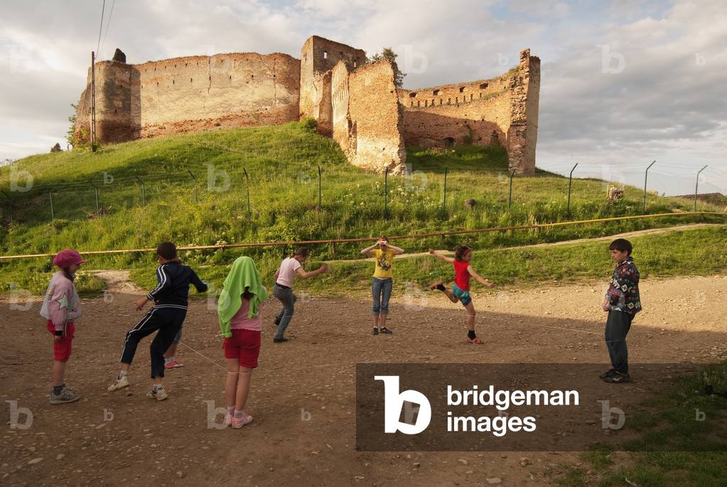 Romania, Kids playing near old ruin, Slimnic (photo)