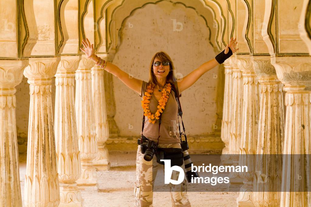 Female Tourist with Lots of Cameras At Amber Fort, Jaipur, Rajasthan, India (photo)