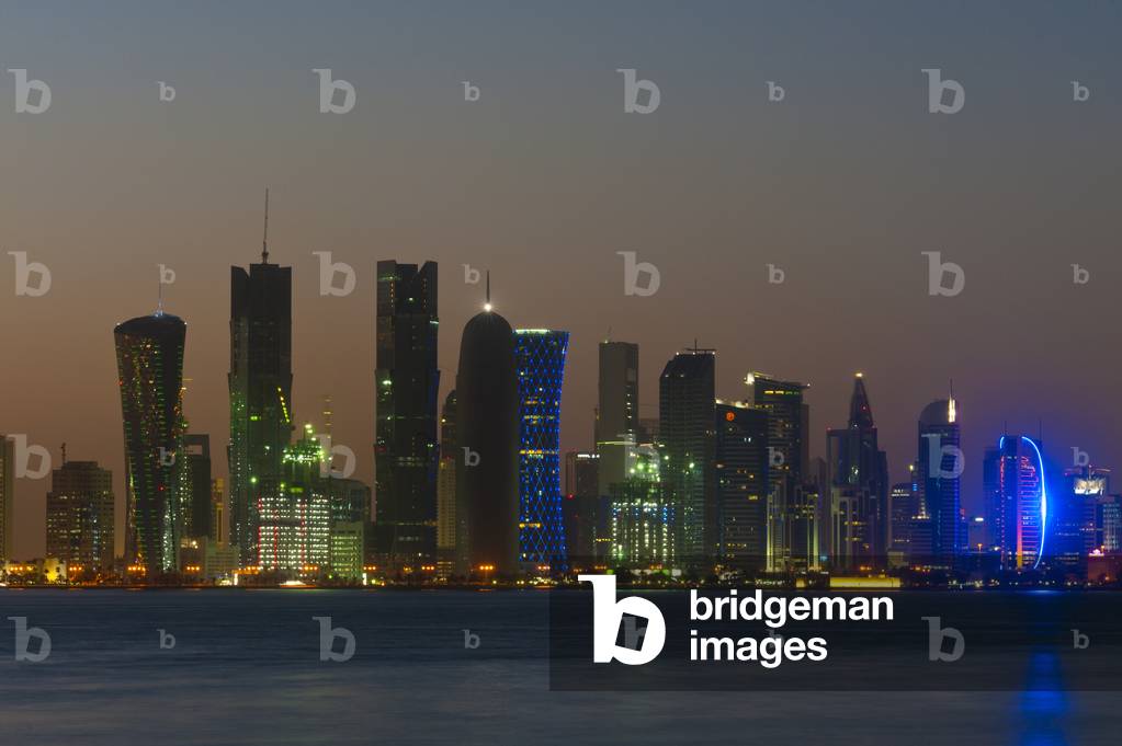 Modern city skyline at dusk, Doha, Qatar (photo)