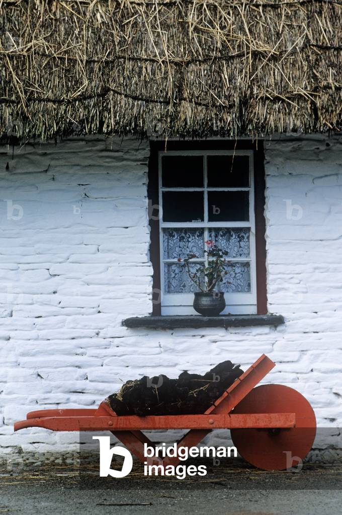 Wheelbarrow In Front Of A Window Of A Cottage, Bunratty Folk Park, Bunratty, County Clare, Republic Of Ireland (photo)