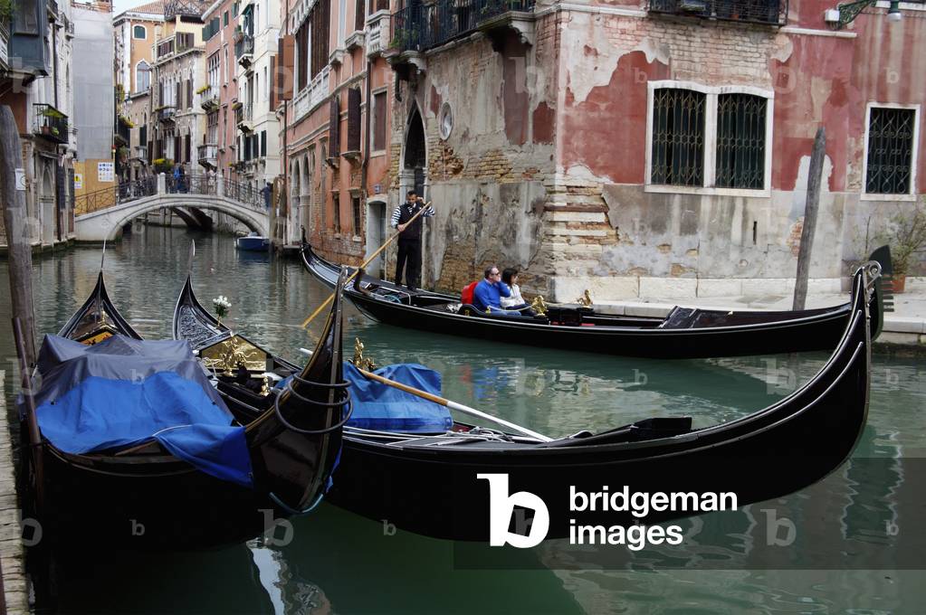Gondolas in a canal, Venice, Italy (photo)