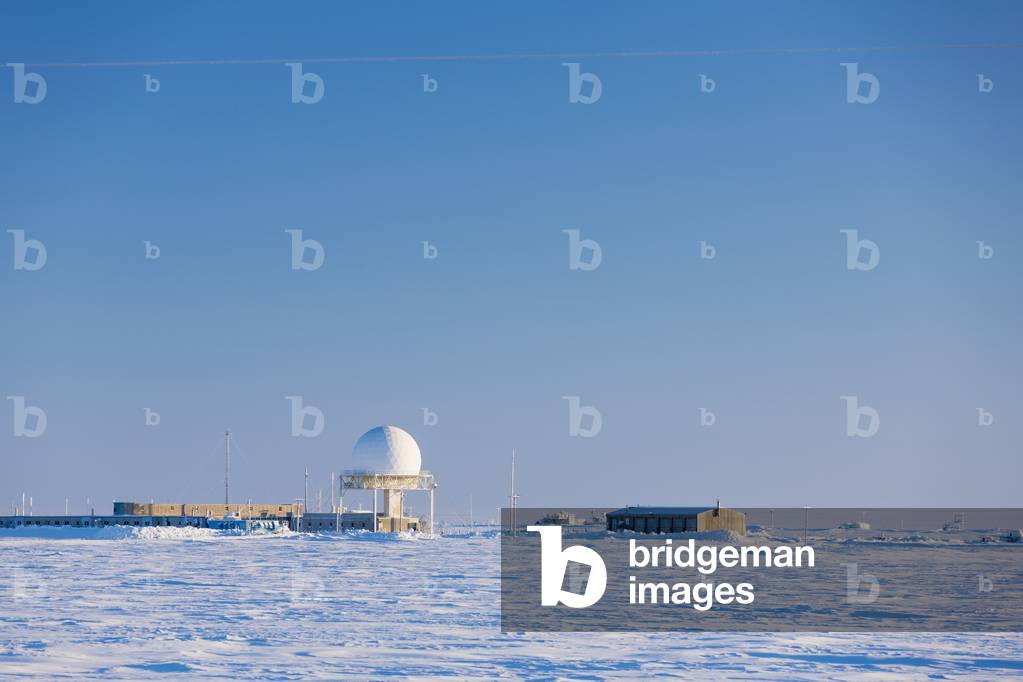 A radar dome and buildings of the Barrow naval base sit in a snowy landscape, Barrow, Arctic Alaska, Winter (photo)