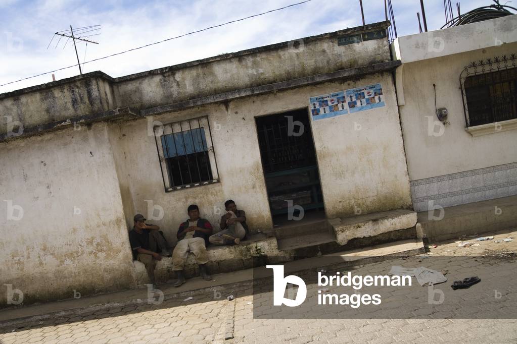 Central America, Three Men sitting outside a Run down Building, Patzicia, Guatemala (photo)