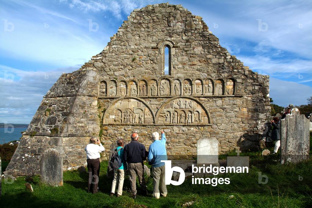 Ardmore Cathedral, County Waterford, Ireland; Tourists Examining Carvings On Ruins (photo)