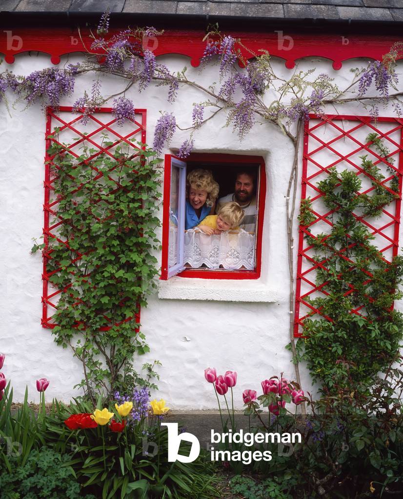Co Kerry, Ireland; Family Looking Out Cottage Window (photo)