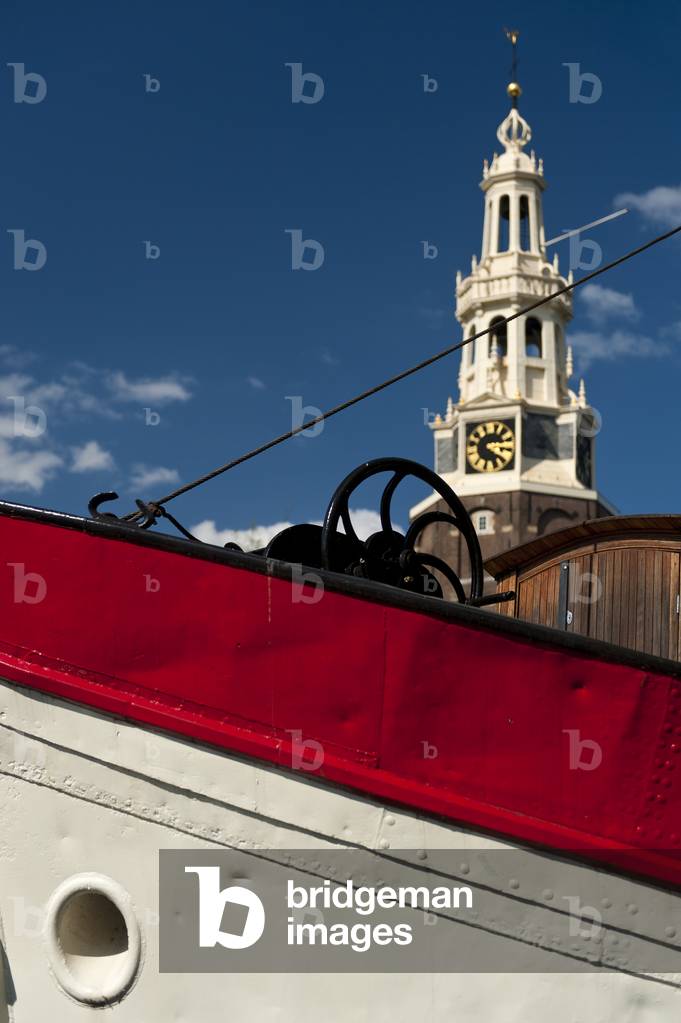 Bow of traditional Dutch barge with the Montelbaanstoren behind, Amsterdam, Holland (photo)