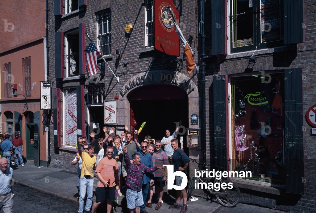 Young men celebrating, outside a pub, Temple Bar, Co Dublin,  Ireland; (photo)