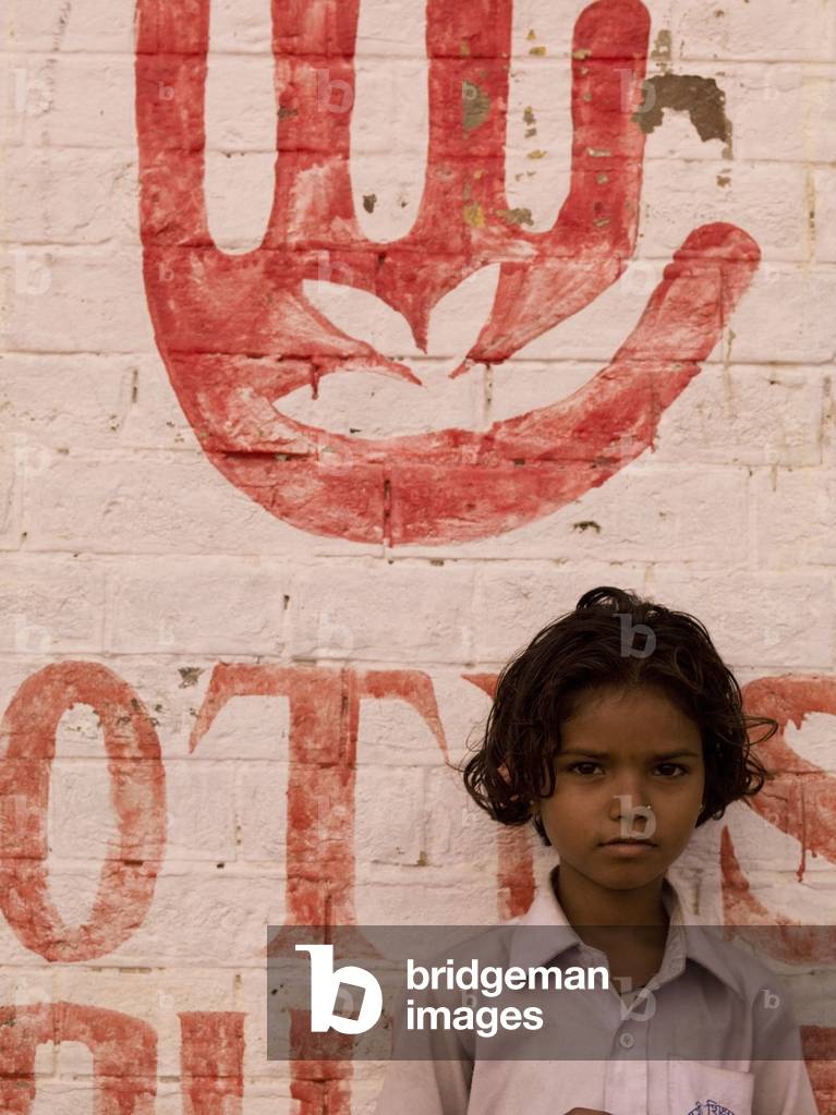Young Indian Girl Standing against a Wall, Varanasi, India (photo)