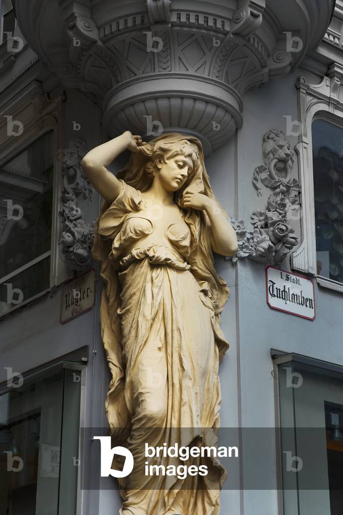 Statue of a woman on the corner of a building, Vienna, Austria (photo)