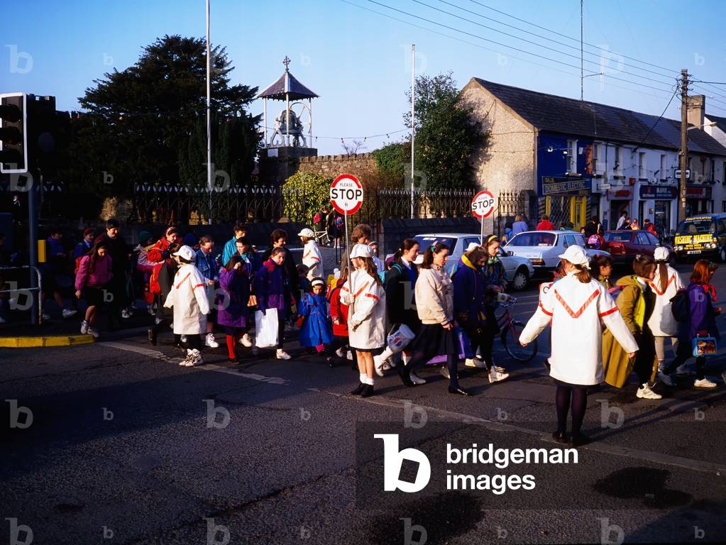School Children Crossing The Road With The School Crossing Patrol (photo)