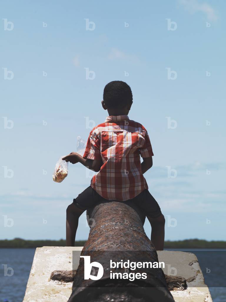 Boy looking out Onto the Indian Ocean, Kenya, Africa (photo)