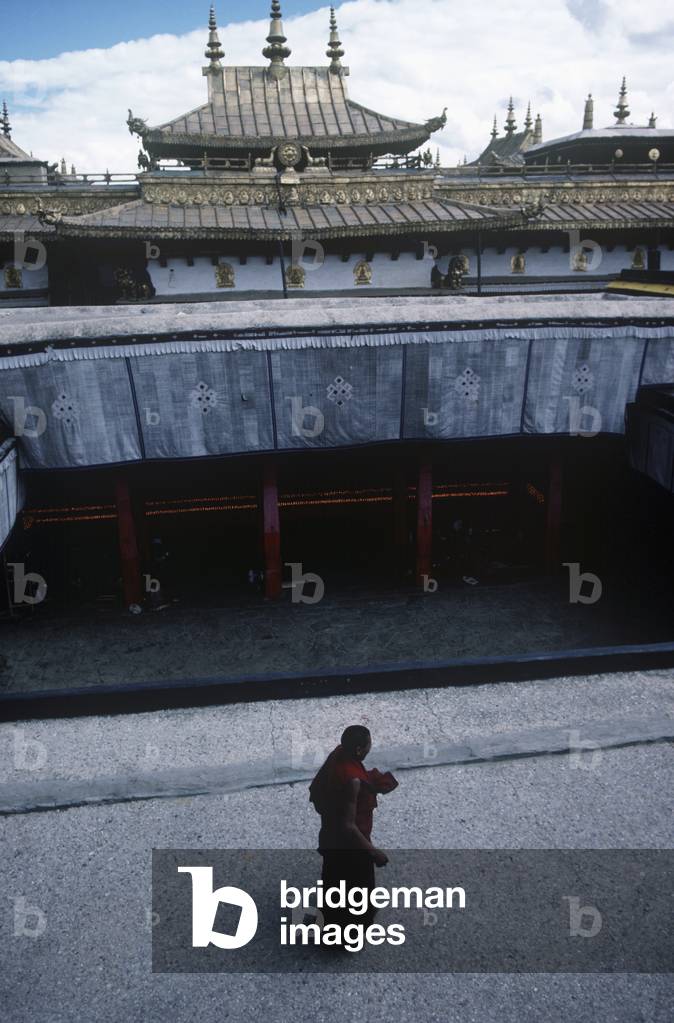 A Monk at Jokhang Temple Entrance, Barkhor Square, Lhasa, Tibet (photo)