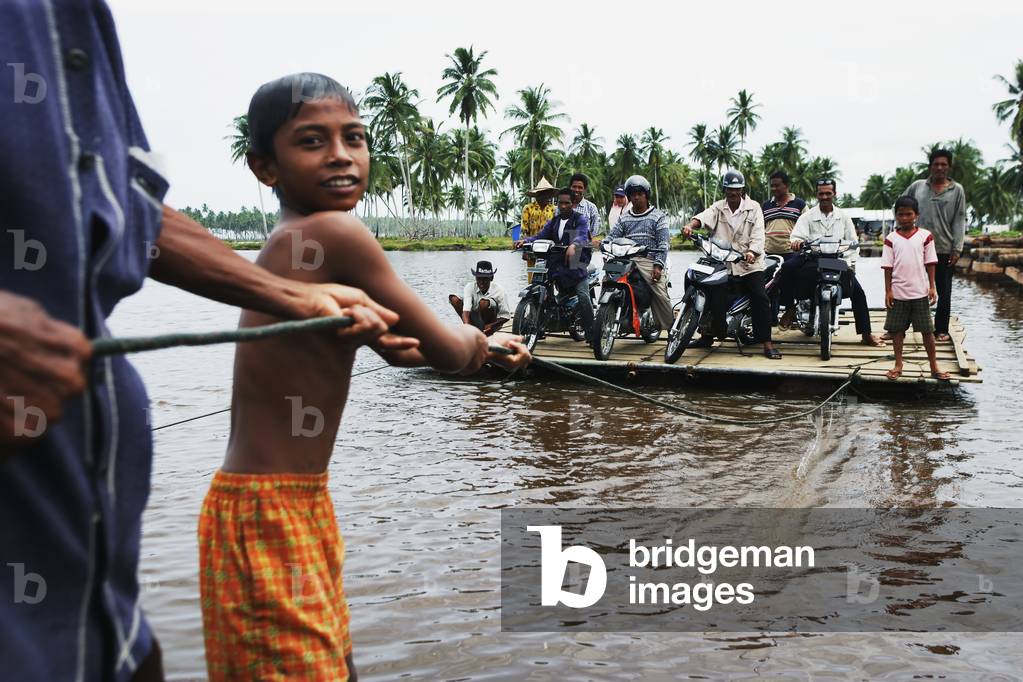 The floating bridge constructed as a temporary means of crossing a coastal inlet, near Meulaboh, following the Indian Ocean earthquake and tsunami, Aceh Province, Indonesia (photo)