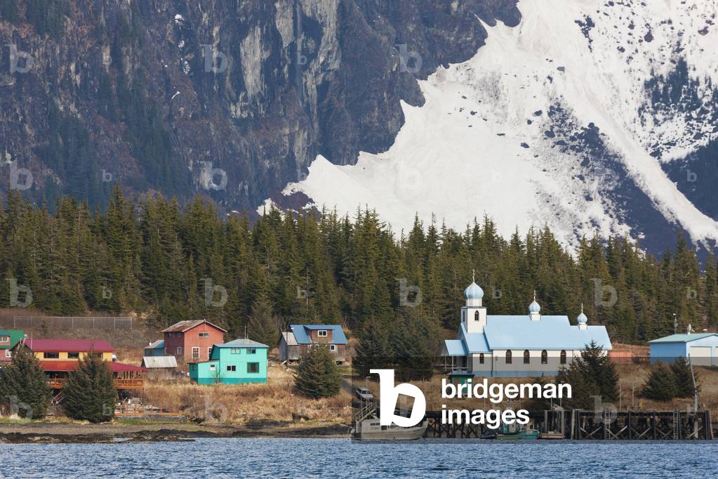 Chugach mountains flank a Russian orthodox church and village homes of the native community of Tatitlek in eastern Prince William Sound, southcentral, Alaska (photo)