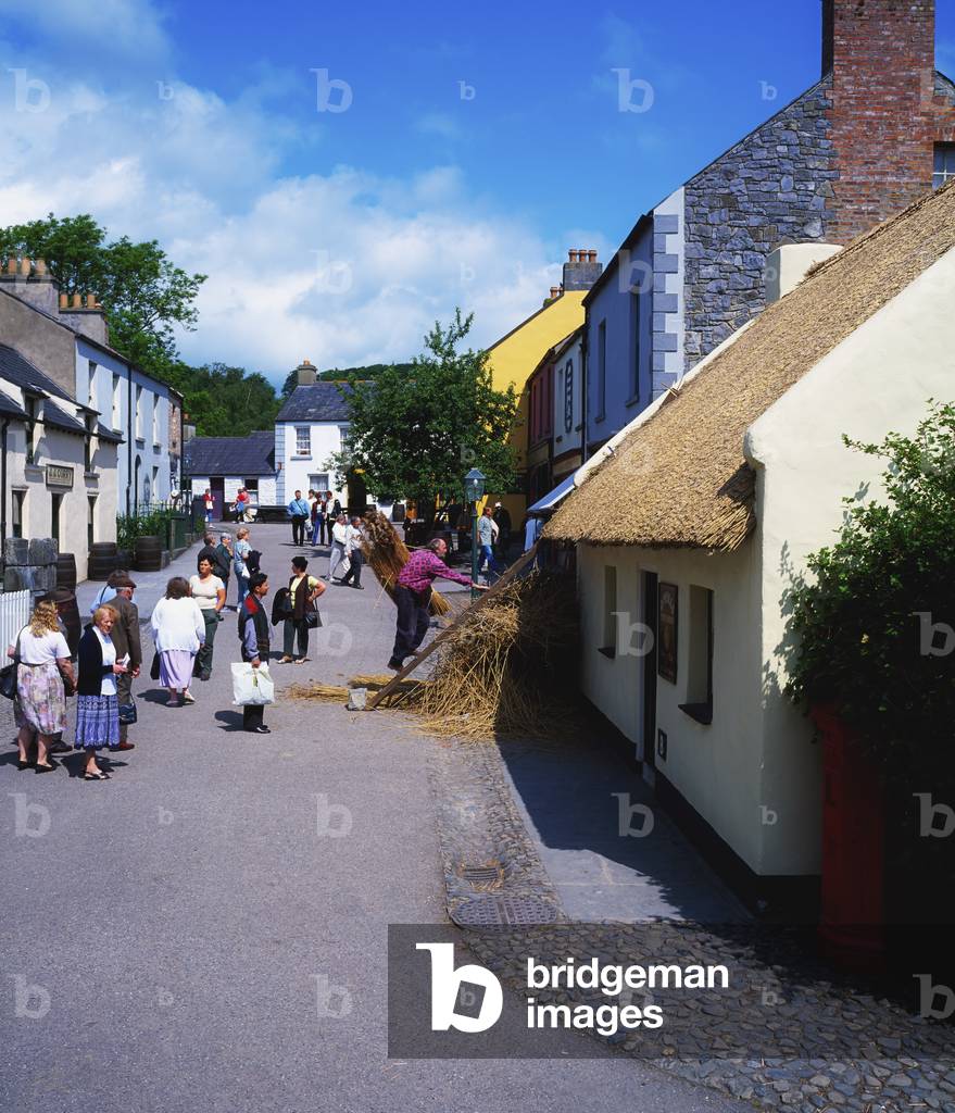 Bunratty Folk Park,Co Clare,Ireland;Person Thatching A Cottage Roof (photo)