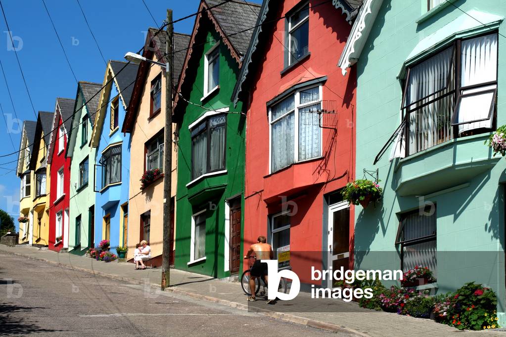 Cobh, County Cork, Ireland; Man Pushing Bicycle Uphill (photo)