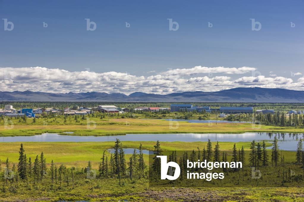 Scenic view of the village of Noatak and the surrounding wetlands, tundra, and Baird Mountains in the distance, Arctic Alaska, Summer (photo)