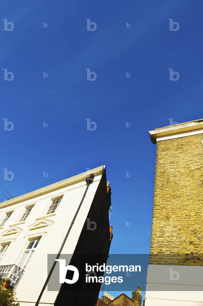 Low angle view of residential buildings against a blue sky, Primrose Hill, London, England, UK  (photo)