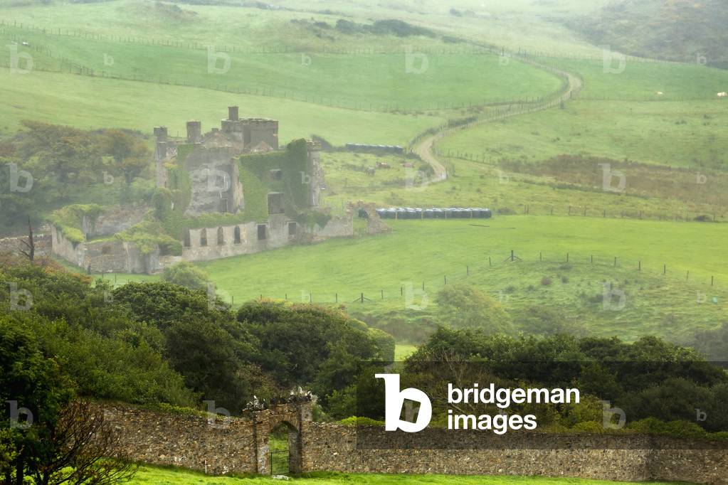 Foggy green pastures with stone wall and stone ruin castle; Clifden, County Galway, Ireland (photo)