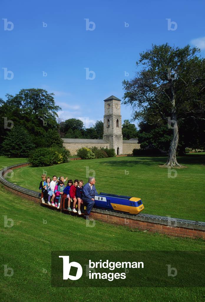 Children Riding A Model Train; Man Driving A Train With A Group Of Children (photo)