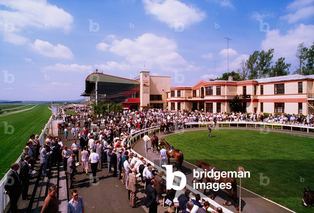 Co Kildare, Ireland; Spectators Watching Horses In The Ring At The Curragh Racecourse (photo)