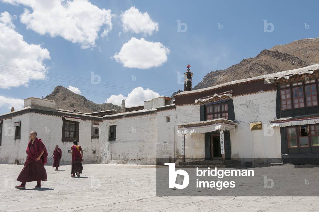 Three young monks walking in Panchen Lamas Tashilhunpo Monastery, Tibetan Friendship Highway, Xigaze, Tibet, China (photo)