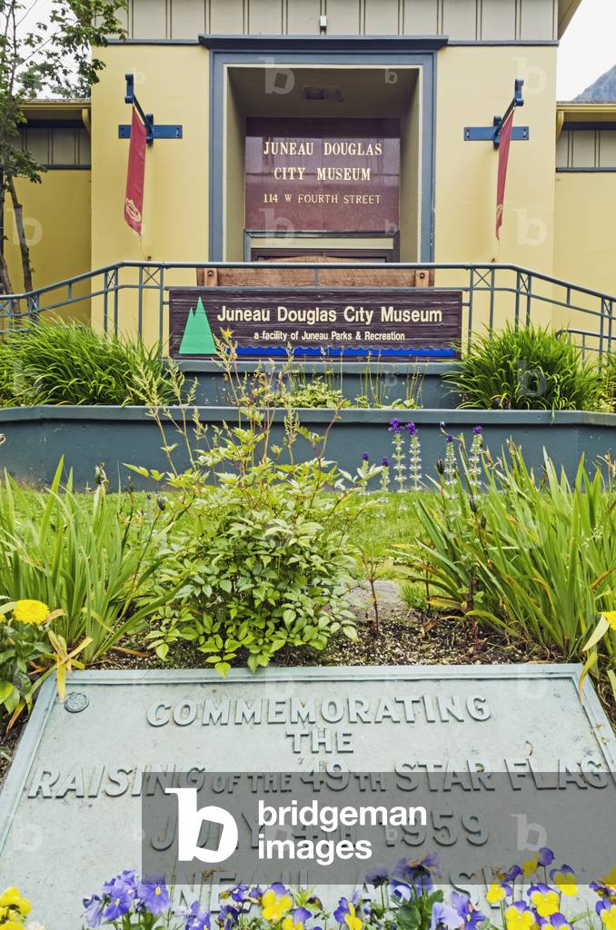 Front entrance of Juneau Douglas City Museum in Juneau with plaque commemorating the raising of the Alaska flag on July 4th, 1959, Southeast Alaska, Summer (photo)