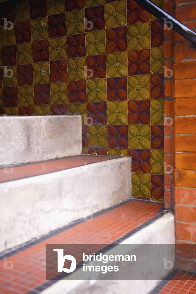 Tile on steps and colourful tile with a floral pattern on the wall, London, England, UK  (photo)