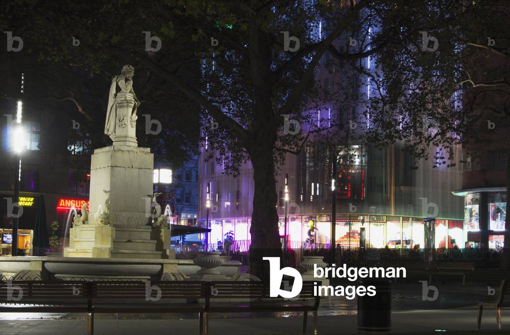 Buildings and a statue illuminated at night, London, England, UK  (photo)
