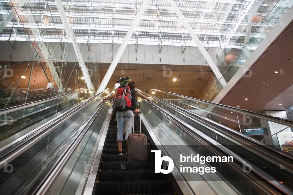 Low Angle View of Woman on Escalator, Singapore (photo)