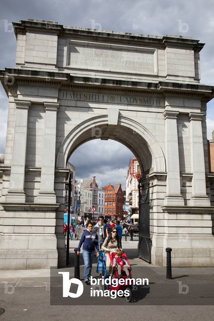 Pedestrians Walking Through An Arch And Across The Street; Dublin City County Dublin Ireland (photo)