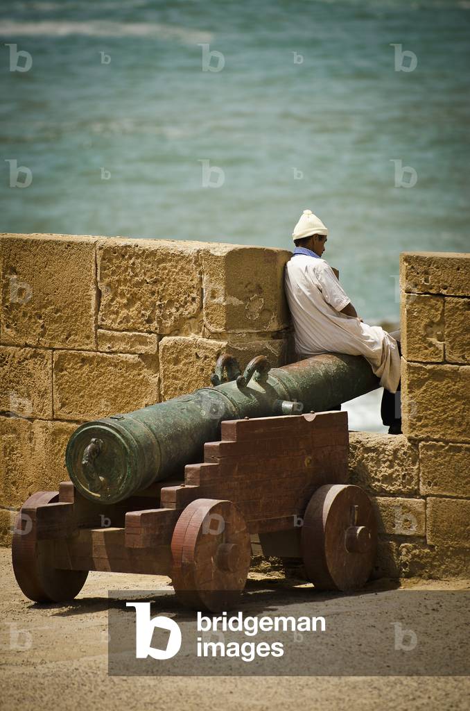 Mature Man Sitting on Cannon, Morocco (photo)